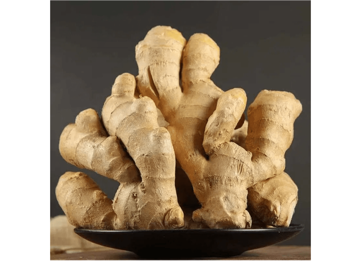 Large yellow ginger roots arranged on a plate